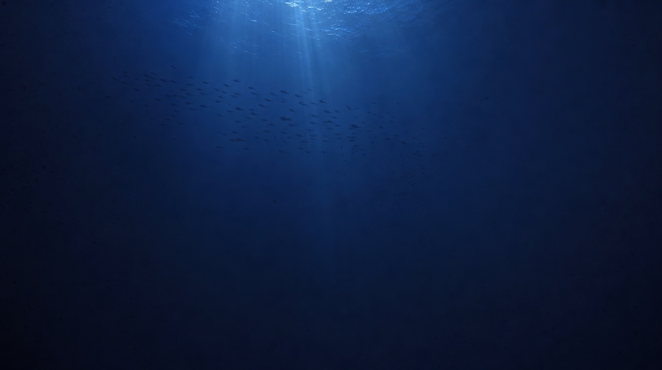 Faint shafts of blue light fading into the deep ocean twilight zone